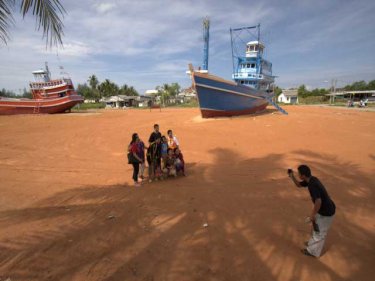 Tourists are drawn to the trawlers at Nam Khem