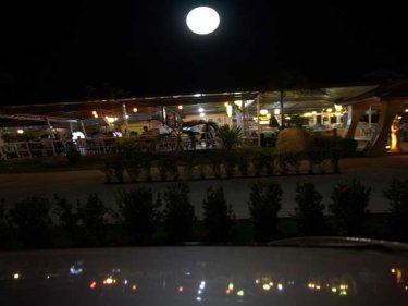 The Ko Tee Buffet, an oasis in the dark. Don't be fooled. The moon is a globe light. The canal reflections, a car roof