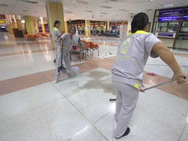 Cleaners ready the empty departure hall today for a mass exodus