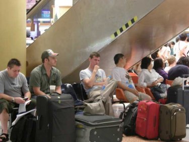 Passengers wait for news at Phuket International Airport