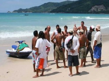 A jetski row plays out on Patong beach, with a police officer intervening