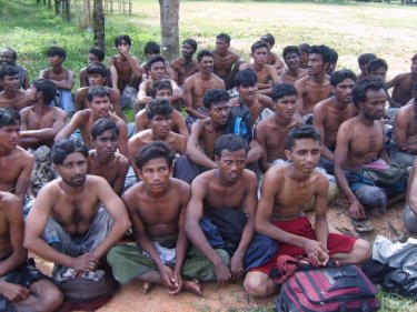 Rohingya men being checked for weapons in an Andaman town