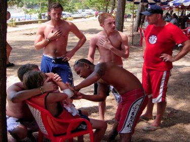 The jetski girl's wound is treated under the trees at Nai Harn beach