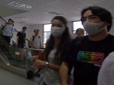 Phuket arrivals from Hong Kong already in face masks are scanned