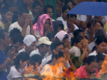 Praying Mon through a fiery haze at Phuket's Big Buddha