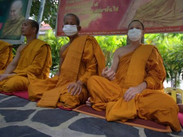 Phuket monks mask up for the media in a promotion today