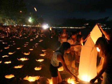 Candles burn on Patong beach, Phuket, to mark the first anniversary