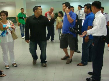 The Immigration colonel, in the black shirt, ''arrests'' welcomers