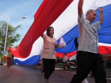 Marchers parade in protest through the streets of Phuket City