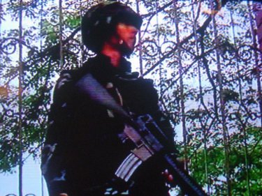 A soldier waits in Bangkok: red reinforcements have been sent south