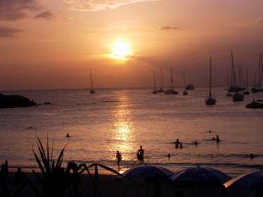 Phuket King's Cup Regatta yachts enjoy the sunset off Phuket's Kata beach