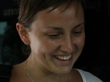 Smiling broadly, Russian Valeriya Verbitskaya collects her camera