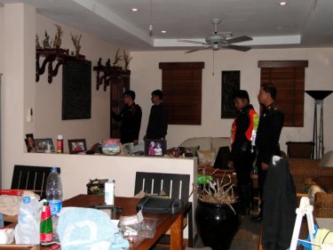 Police at the Baramee Road, Patong, house wrecked by raiders this week