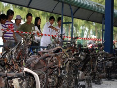 Onlookers check the destroyed motorcycles in Phuket City this afternoon