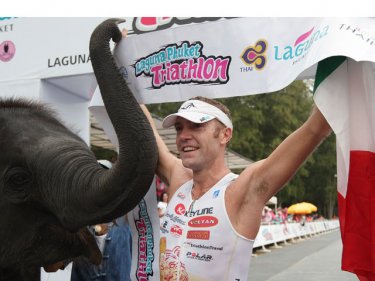 Phuket triathlon winner Massimo Cigana celebrates big with small elephant