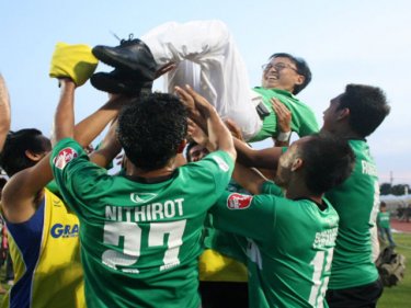FC Phuket chairman Paiboon Upatising is tossed by jubilant players