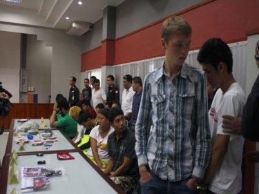 The young Russian suspect, handcuffed among other Phuket suspects