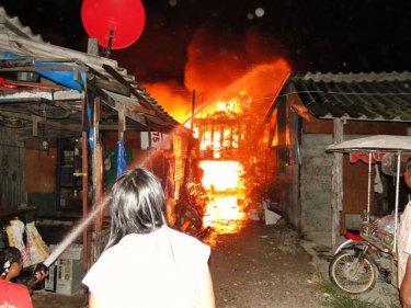 Fighting the fire as it destroyed a shanty town in Patong on Sunday