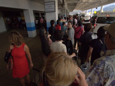 The first of four queues for departing tourists comes outside Phuket airport