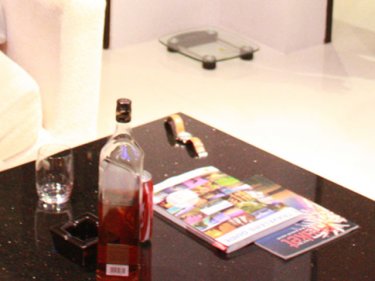 The table with the whisky and Coke in the Bangla Suites apartment