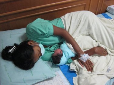 Burmese mother and newborn child: beds fill corridors at Vachira Phuket