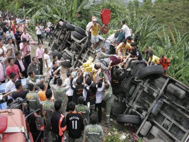Phuket rescuers toil to bring passengers out from the overturned bus