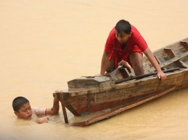 Fun in the water: Boys enjoy a break from long boat racing at Koh Panyee