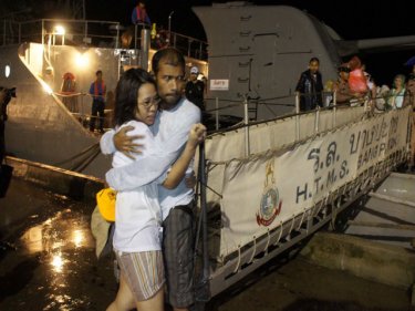 A couple hug after being rescued by the Royal Thai Navy from offshore islands. Two vessels arrived back last night north of Phuket