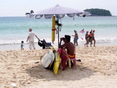 A single lifeguard keeps an eye on swimmers at Phuket's Kata beach