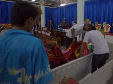 One of the Phuket crash victims is covered before the coffin is sealed