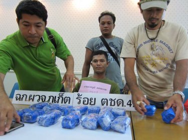 Phuket officers pile up the evidence in front of Pakbhum Praynga