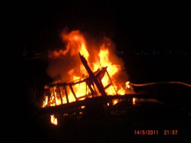 The time is just before 10pm and a boat blazes in the night off Phuket