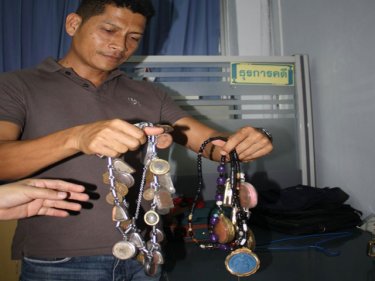 Amulets worn by Sanit Choochern that he says saved him from killers