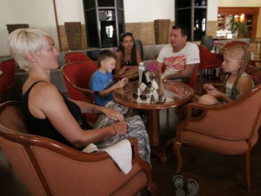 A family from Australia's Gold Coast waits during the Phuket stranding