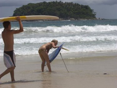 Surfers at Kata, site of the Phuket titles for two years before 2011