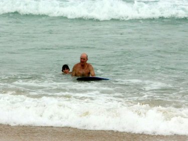 Swimmers in the water at Phuket's Karon even though the beach was closed yesterday after the disappearance of a tourist