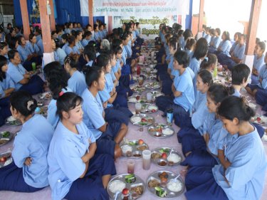 Phuket Prison's female inmates sit down for a birthday meal today