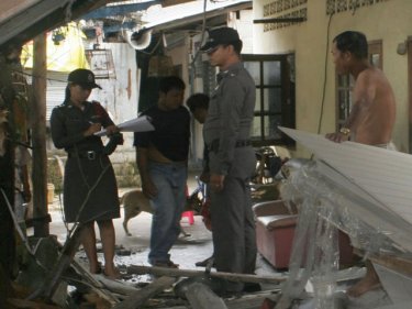 Police investigate the aftermath of the Phuket hillside truck crash