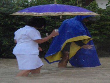 A nurse struggles to get to work as Patong disappears under floods