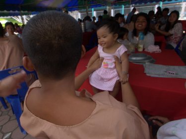 A Phuket prisoner dandles his daughter for a few priceless moments