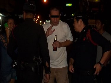 A drunken British man talks to police in Patong last night