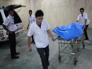The body of the man is wheeled from  the Patong resort last night