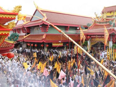 A large crowd raises the lantern pole at Jui Tui temple in Phuket City to start the nine-day Vegetarian Festival on Phuket.