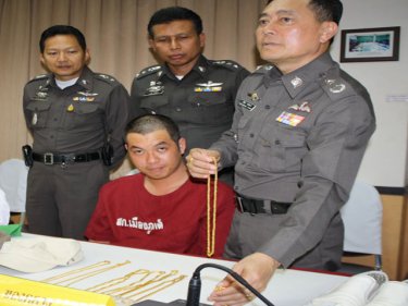 Phuket Police Commander Major General Pekad Tantipong with accused gold raider Techin Kongsinon and part of his haul today