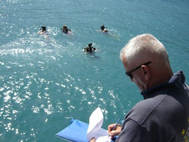 Divers in the water looking to clear rubbish from a popular Phuket site
