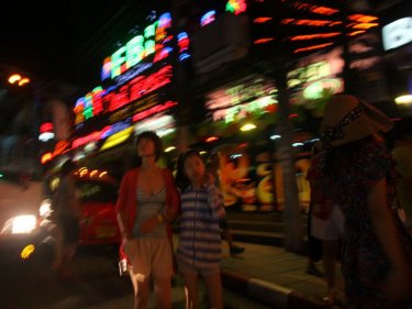 Tourists near the Taipan nightclub in Patong, scene of the chopper attack