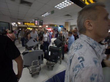 The Phuket crush . . . touts mingle with arriving airport  passengers