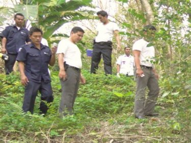 Observers gather at the spot where the unidentified body was found