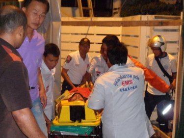 The injured Phuket firefighter is carried out of the Patong resort last night