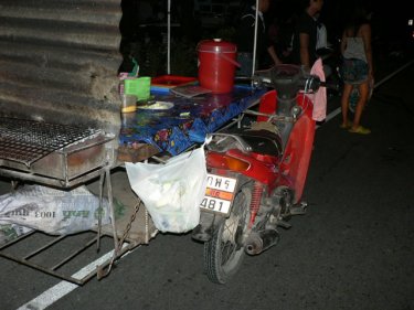 The vendor's stall on wheels that the motorcycle clipped from behind